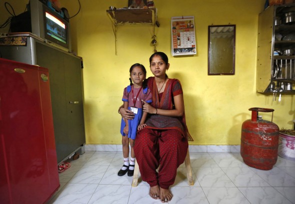 (Via the Atlantic) India: Sulochna Mohan Sawant, 23, with her five-year-old daughter Shamika Sawant inside their home in Mumbai, on February 13, 2014. Sulochna, who works as a maid, wanted to become a doctor when she was a child. However, she could only study until the age of 14. Sulochna wants her daughter to become a teacher, Shamika also wants to become a teacher. (Reuters/Mansi Thapliyal)