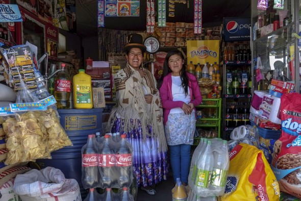 (Via the Atlantic) Bolivia: Lucia Mayta, 43, and her daughter Luz Cecilia, 12, inside their bodega in La Paz, on February 24, 2014. Lucia studied until the fourth grade of primary school, and knows how to read and write and do basic math. Lucia runs a bodega, and the family live in a back room. She hopes to build a house in the future. Luz Cecilia is in seventh grade and wants to be a singer. (Reuters/David Mercado)