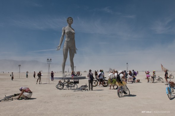 People gather around R-Evolution: The Woman Stands. The third and final sculpture in a series by Marco Cochrane.