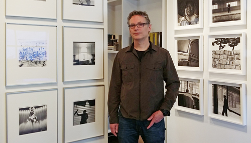 Dick Bakker in front of his prints.