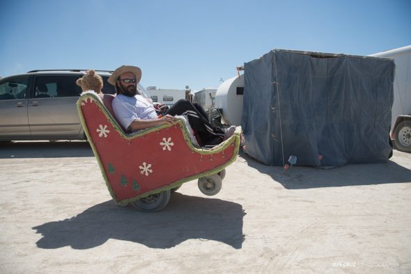 The camp's mechanic, Chris on the "Santa Chair" a personal mutant vehicle loaned to us for the 2014 Burn, built on an electric wheelchair base.